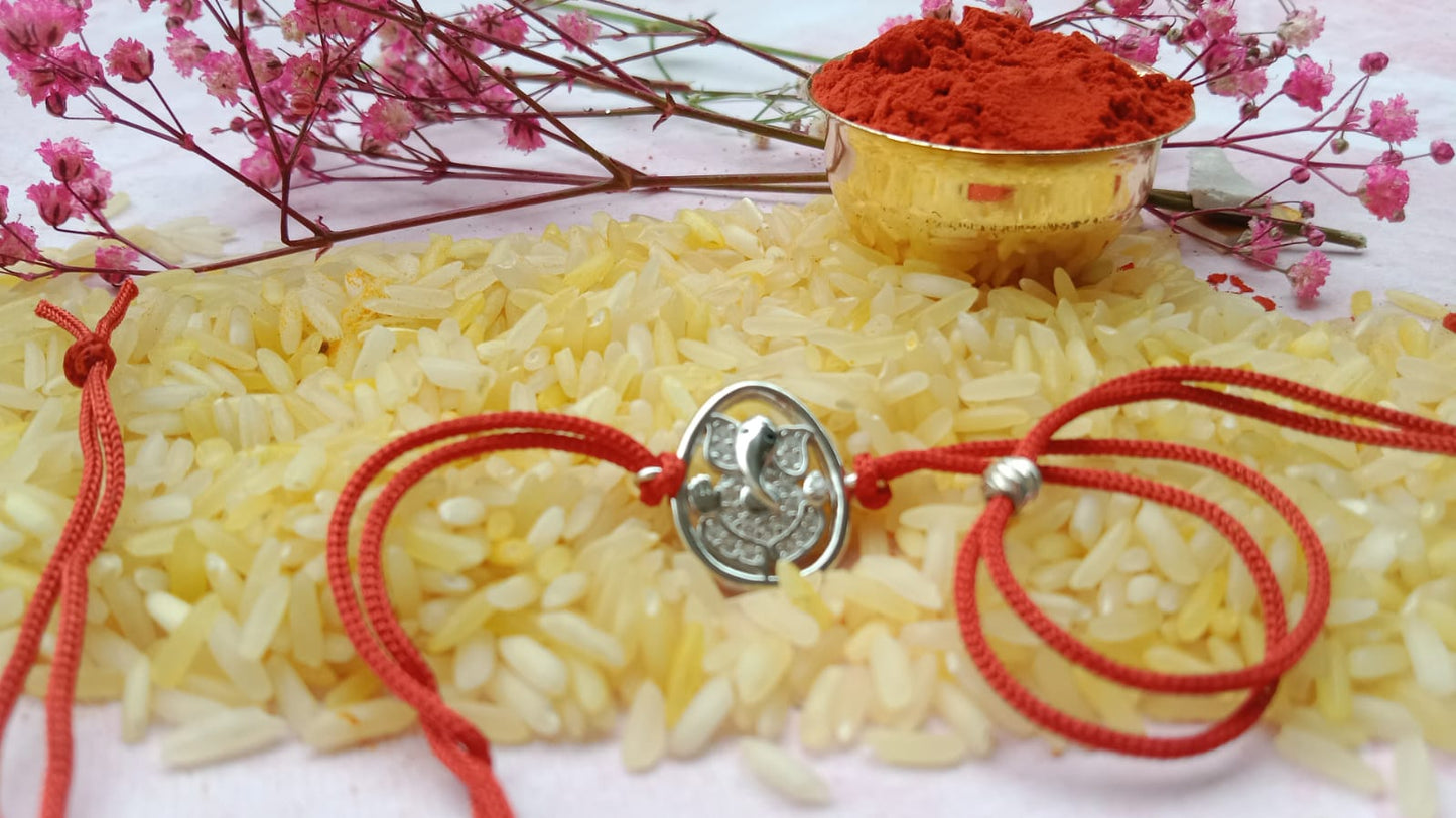 Silver Lord Ganesh Rakhi with Red Thread