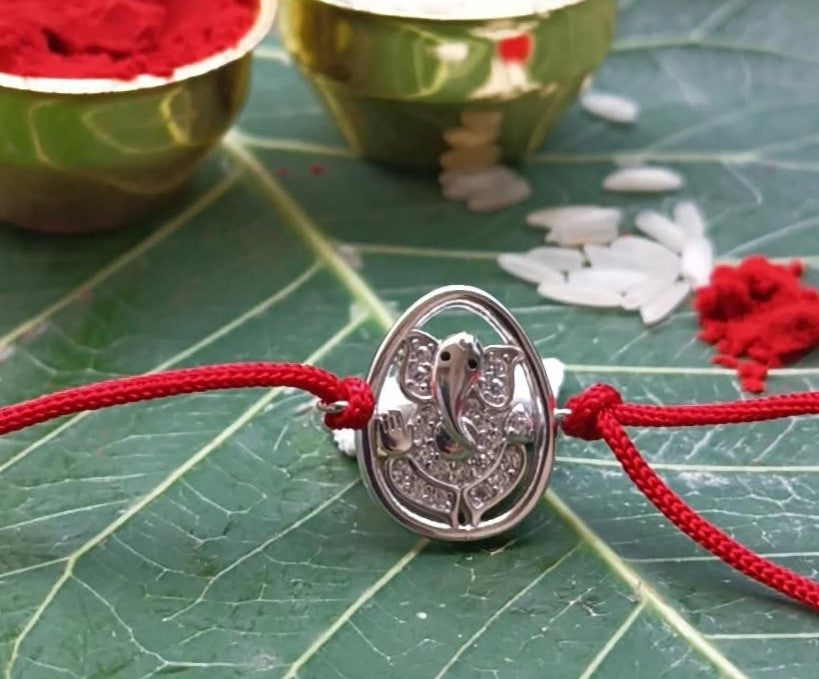 Silver Lord Ganesh Rakhi with Red Thread