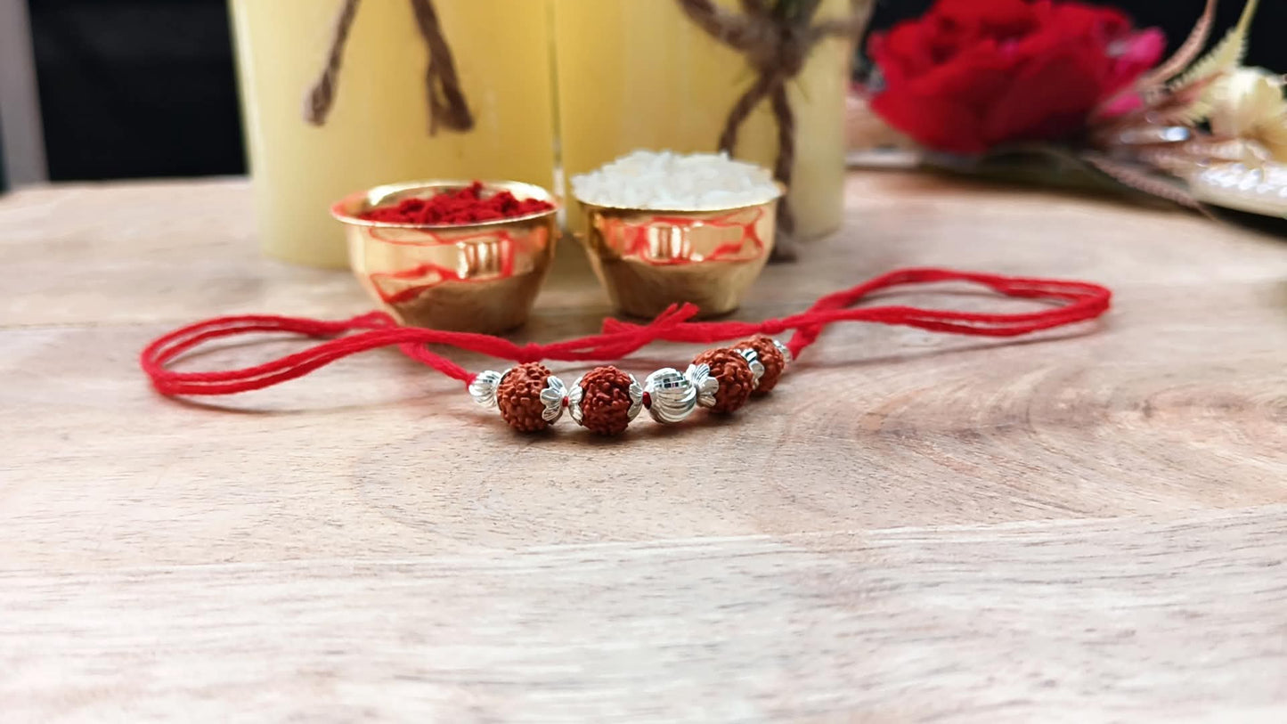 Silver Sacred Rudraksha Rakhi with Red Thread