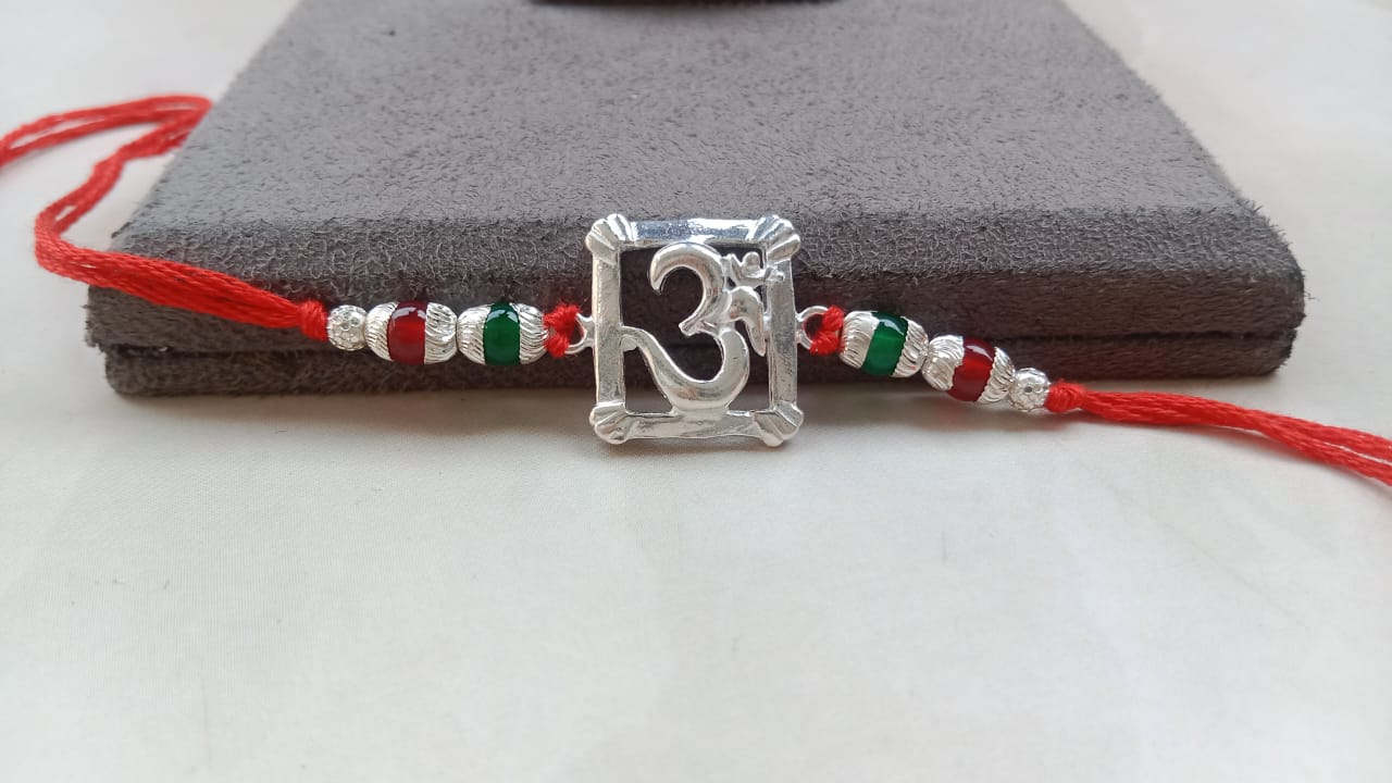 Silver Om Symbol Rakhi with Red Thread