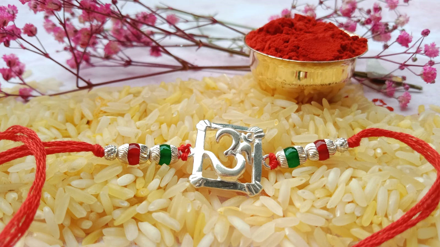 Silver Om Symbol Rakhi with Red Thread