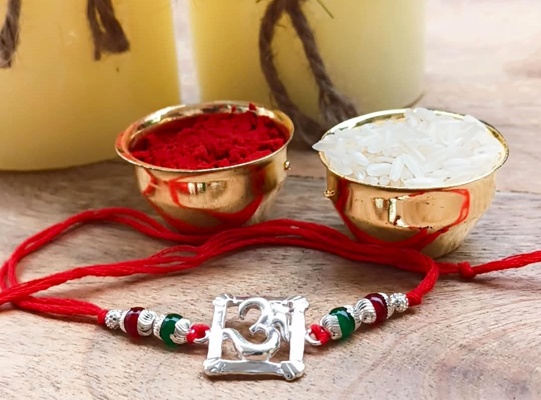 Silver Om Symbol Rakhi with Red Thread