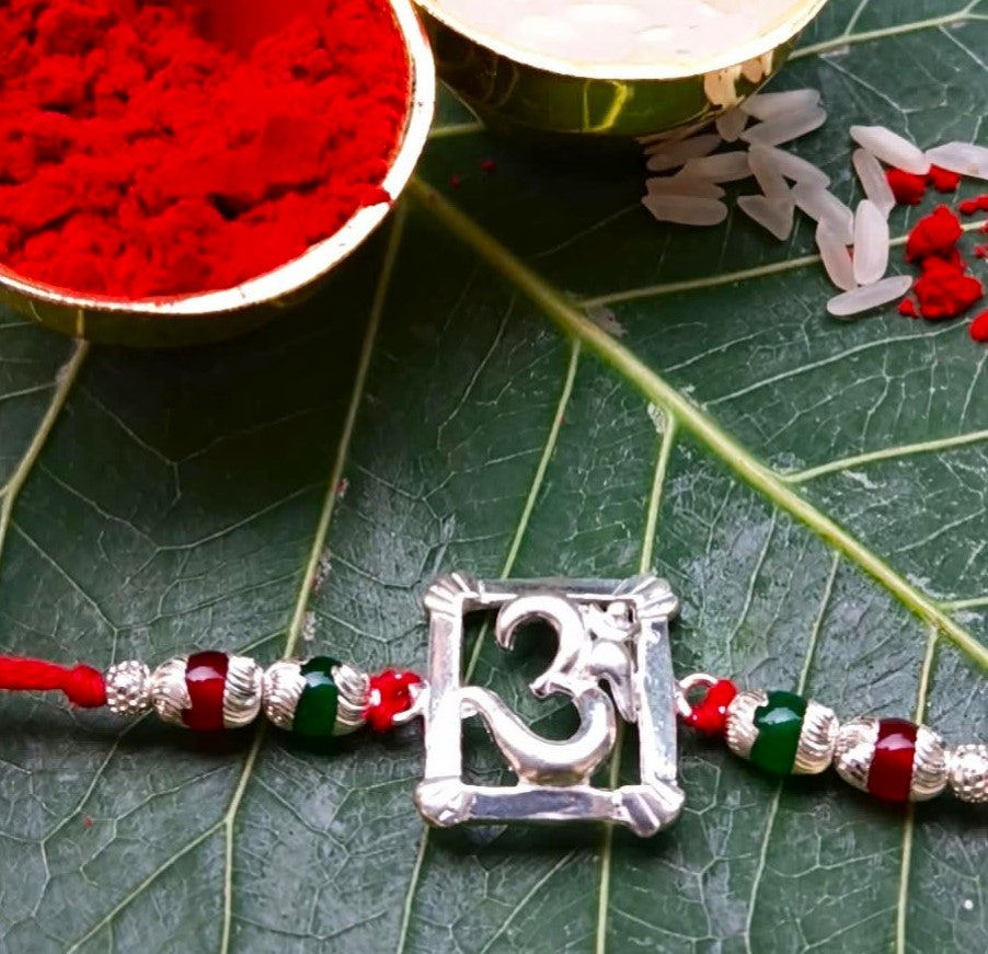 Silver Om Symbol Rakhi with Red Thread