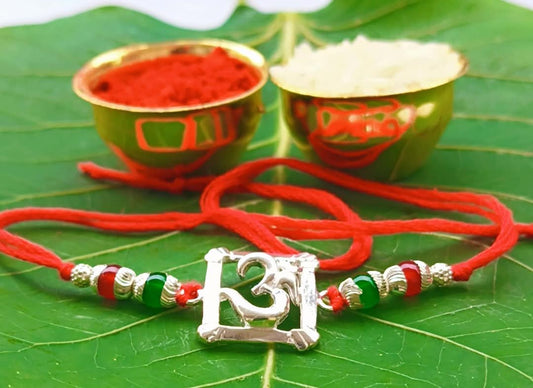 Silver Om Symbol Rakhi with Red Thread