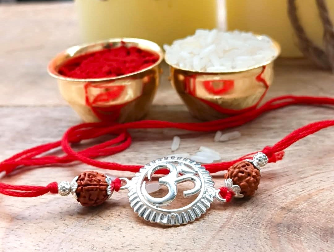 Silver Om Symbol Rudraksha Rakhi with Red Thread